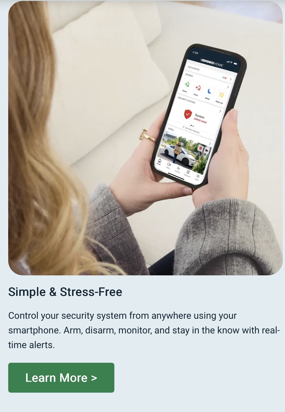 A homeowner using the Brinks Home app on a smartphone